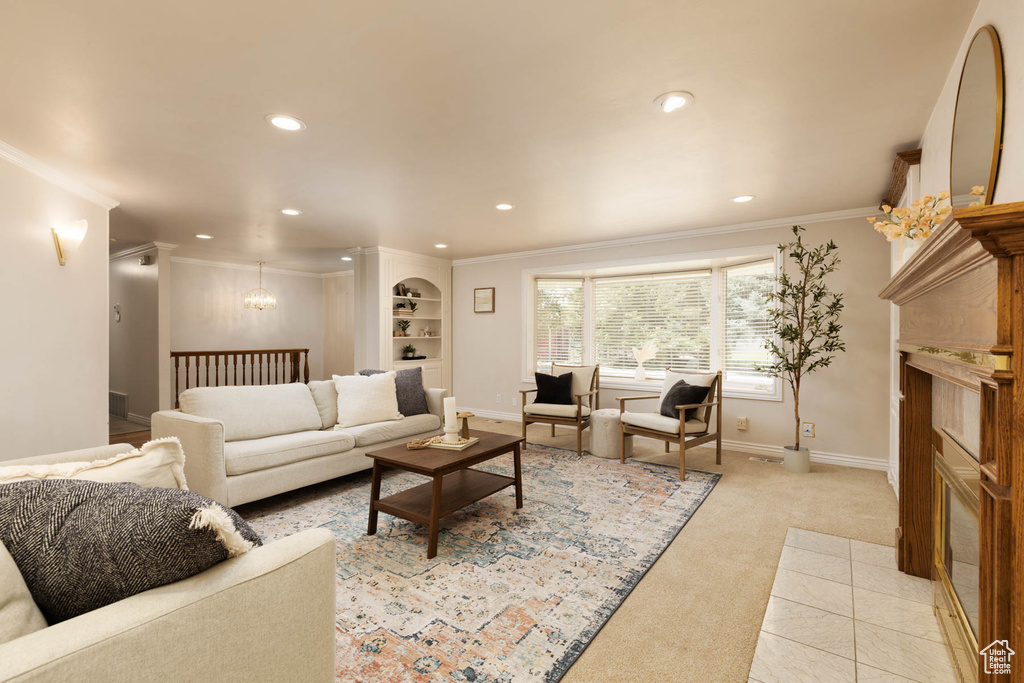 Living area with recessed lighting, crown molding, a chandelier, light carpet, and a fireplace
