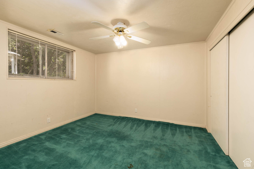 Unfurnished bedroom featuring carpet floors, a closet, and ceiling fan