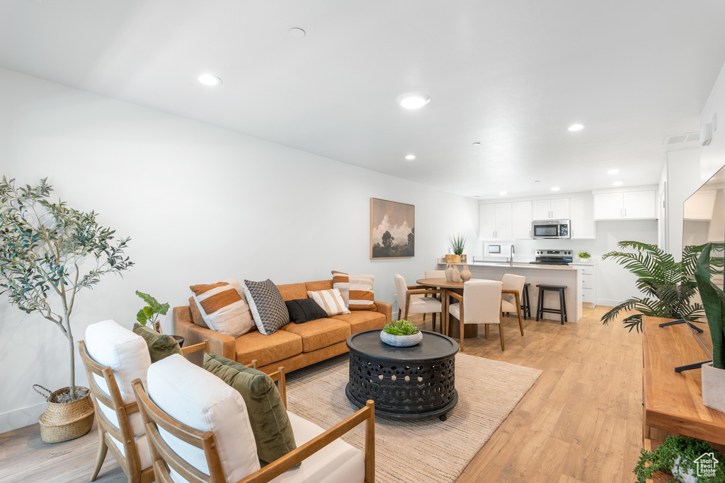 Living room featuring recessed lighting and light wood-style flooring