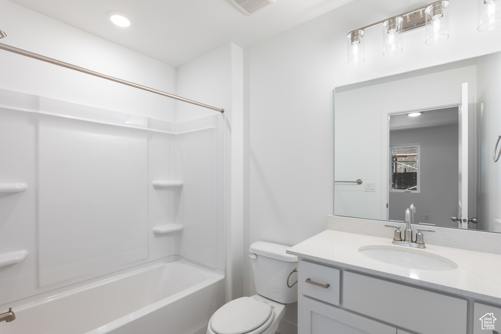 Bathroom featuring vanity, tub / shower combination, and recessed lighting
