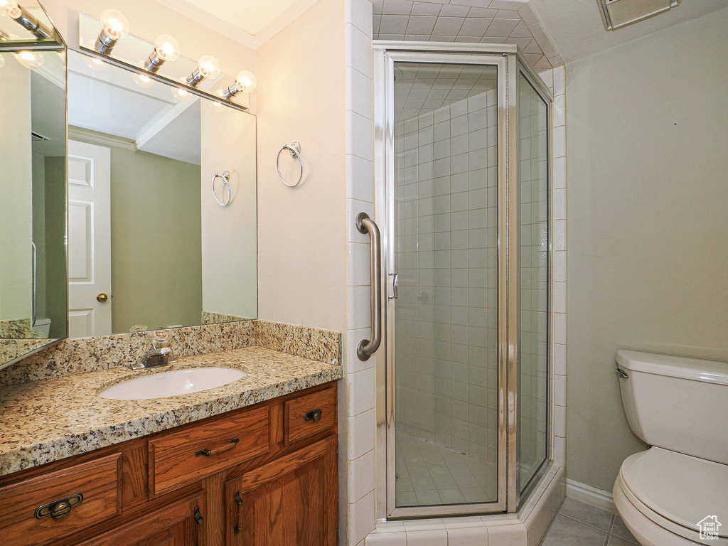 Bathroom with vanity, a shower stall, and tile patterned floors