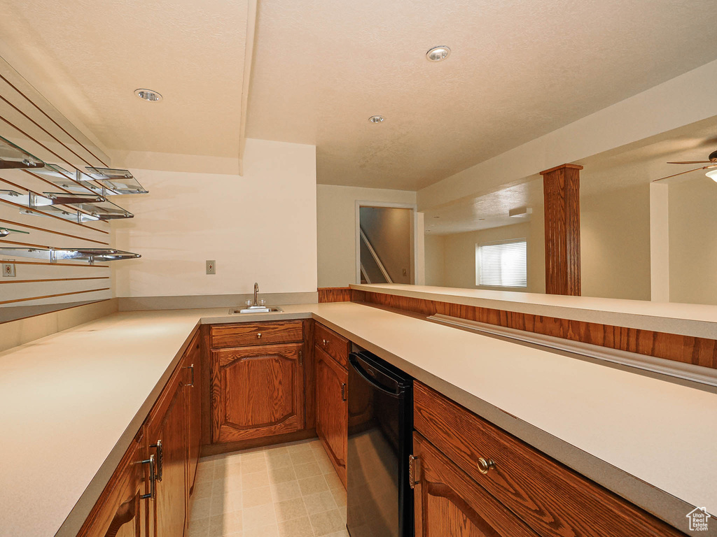 Indoor wet bar with light flooring, a ceiling fan, and refrigerator