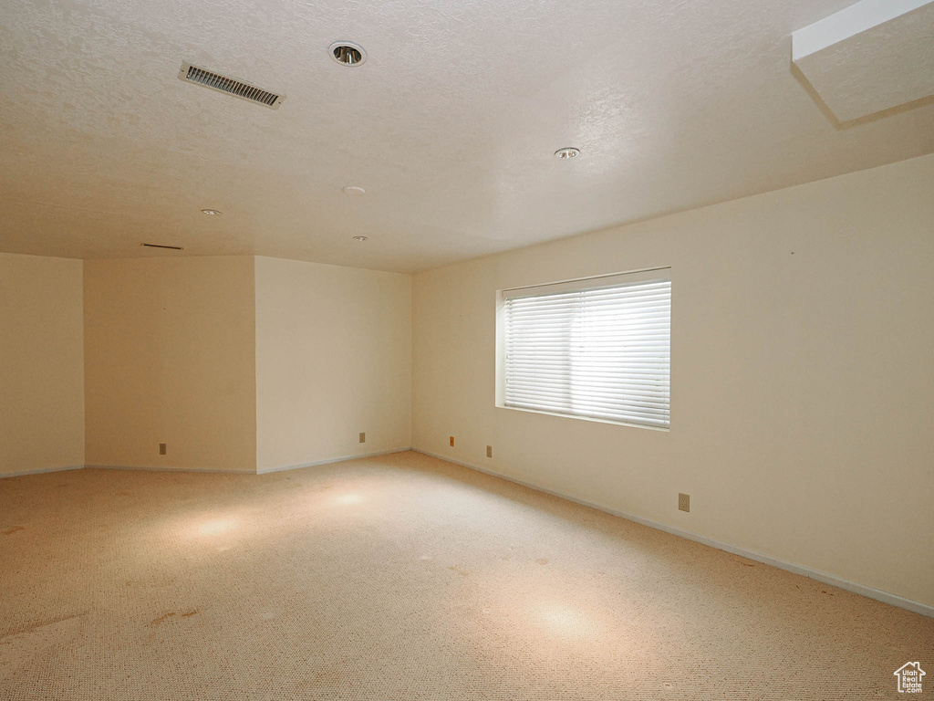 Unfurnished room featuring baseboards and light colored carpet