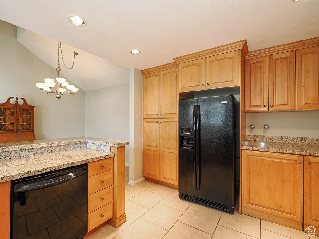 Kitchen featuring black appliances, light tile patterned floors, recessed lighting, light stone countertops, and hanging light fixtures