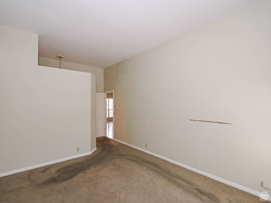 Carpeted empty room with baseboards