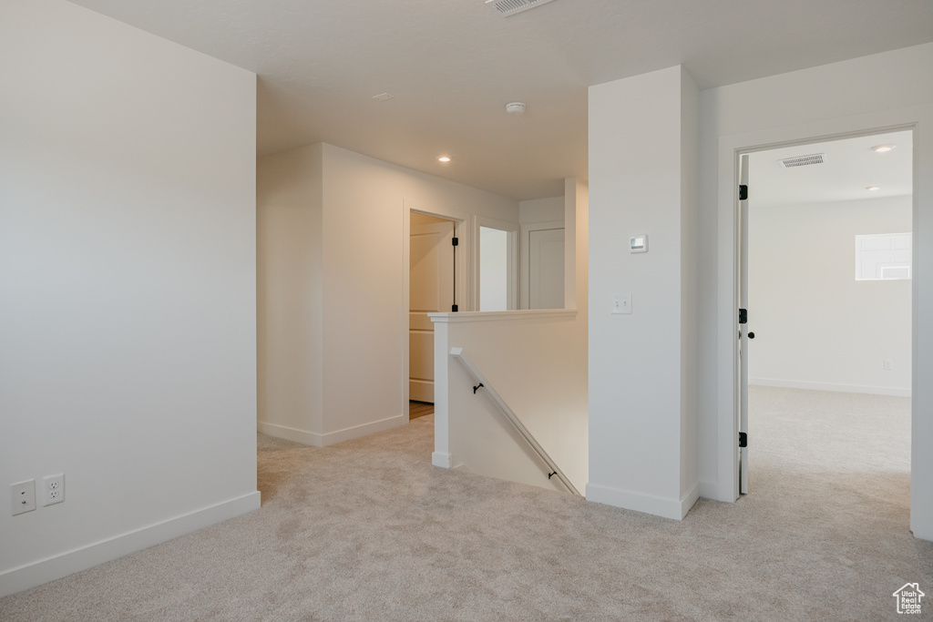 Empty room featuring light carpet and recessed lighting