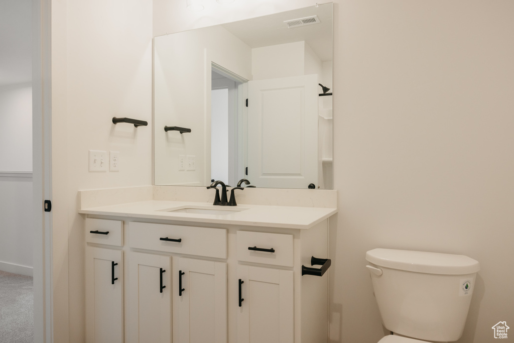 Half bath with vanity and toilet