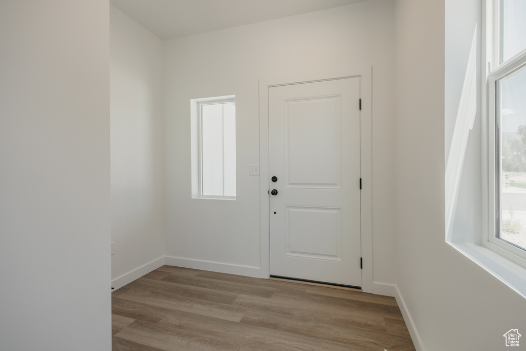 Foyer entrance featuring light wood finished floors and baseboards