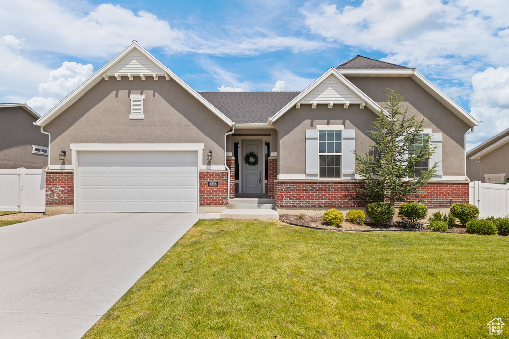 View of front of home with brick siding and stucco siding