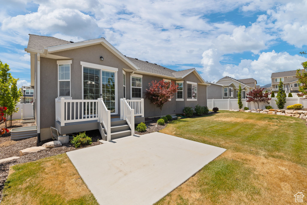 Back of property with a patio, stucco siding, a residential view, and a deck