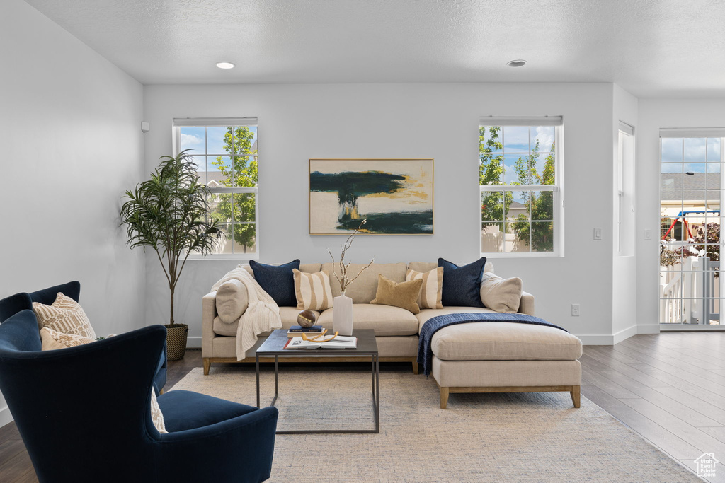 Living area with wood finished floors and a textured ceiling