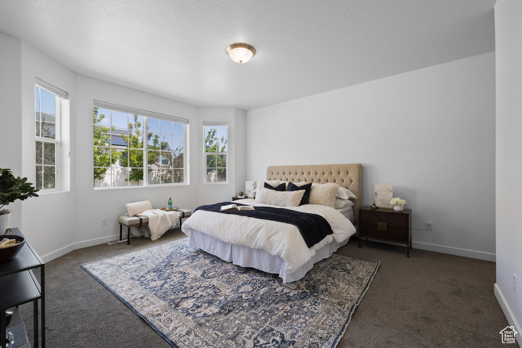 Carpeted bedroom featuring baseboards