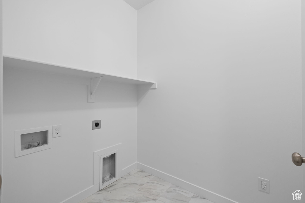 Washroom featuring washer hookup, light marble finish floors, and hookup for an electric dryer