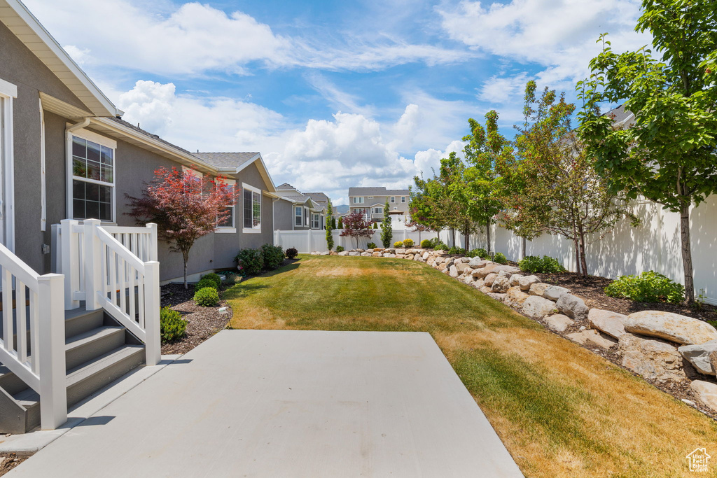Fenced backyard with a residential view and a patio