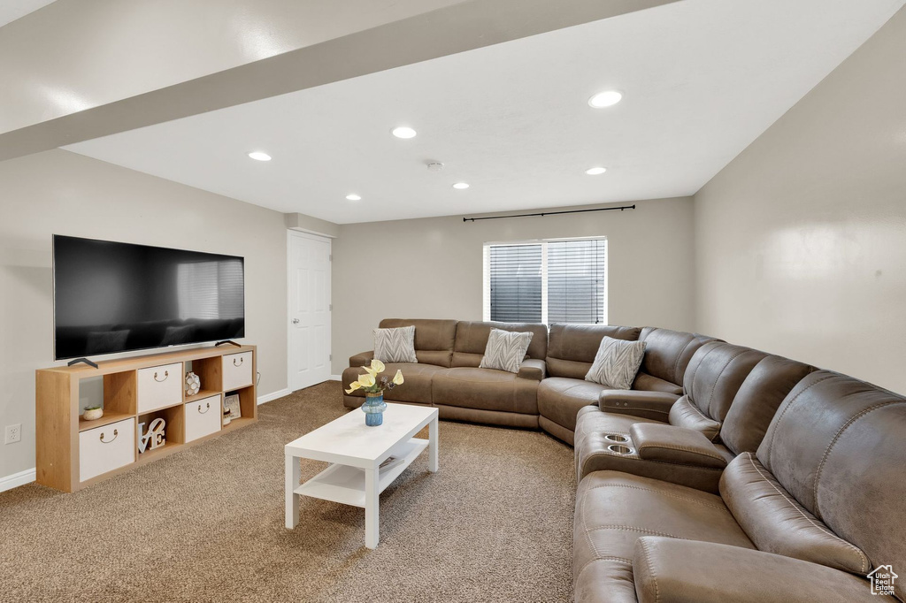 Carpeted living room featuring recessed lighting and baseboards