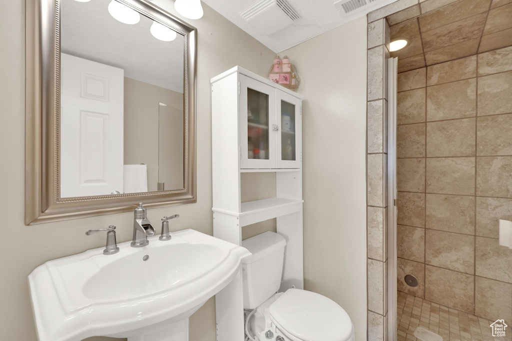 Bathroom featuring a stall shower and a sink