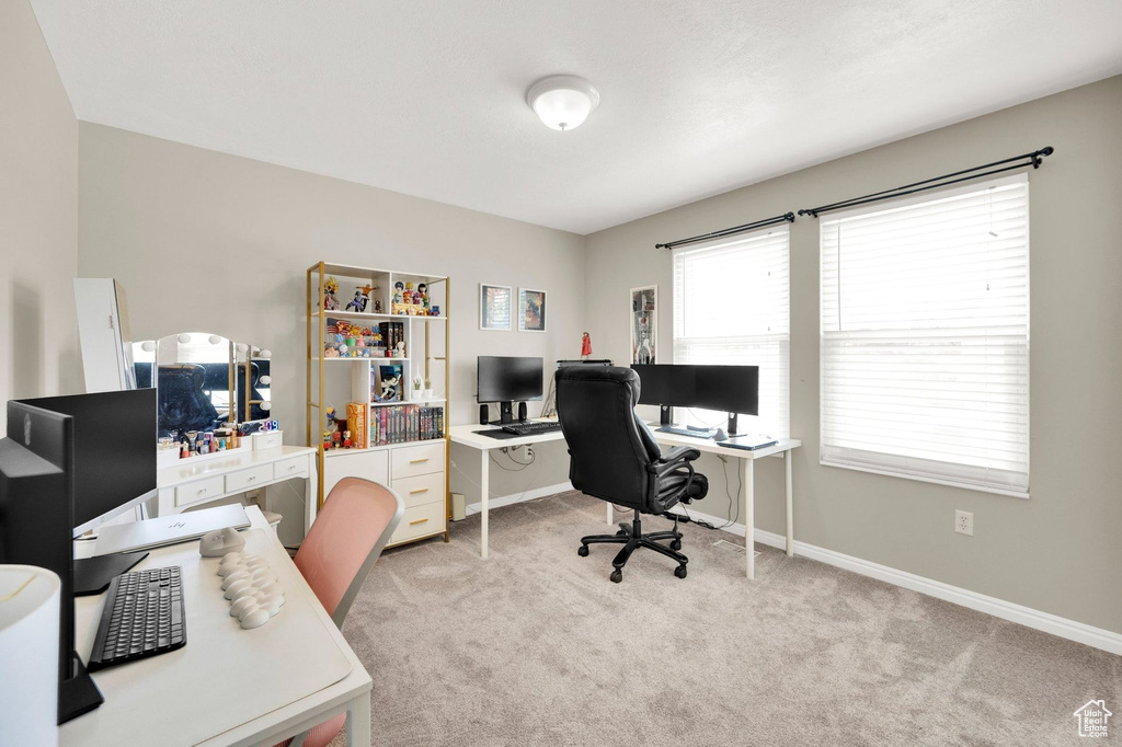 Office space with carpet and baseboards