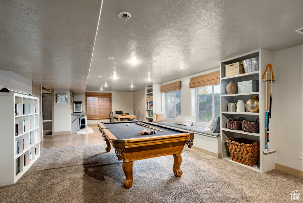 Playroom featuring billiards, a textured ceiling, and carpet