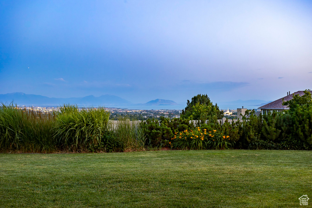 View of green lawn featuring a mountain view