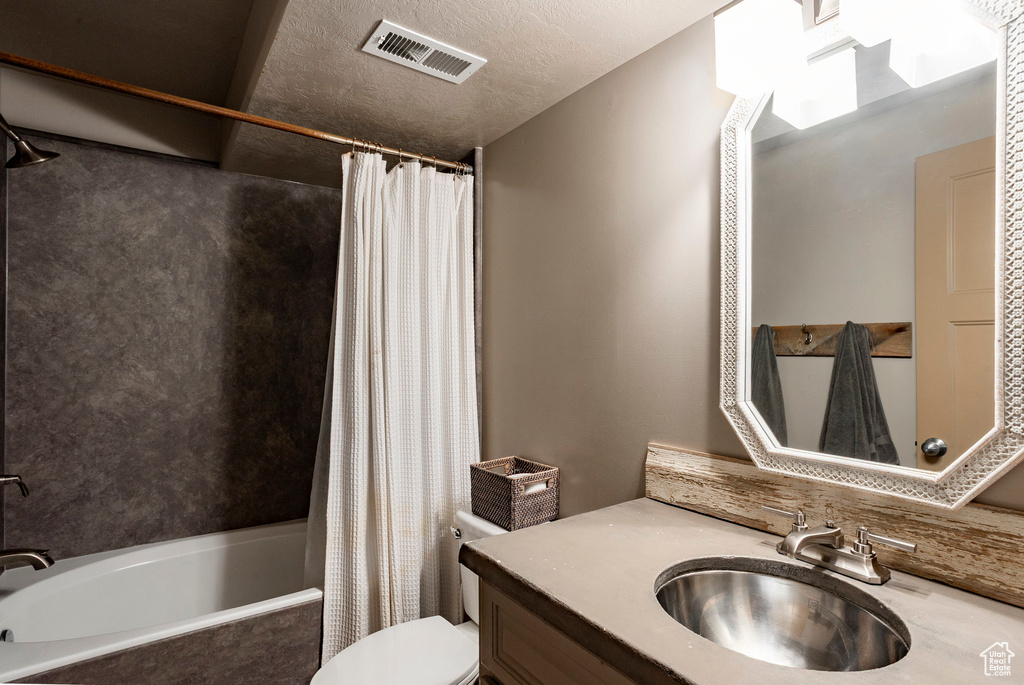 Bathroom with shower / bath combo and vanity