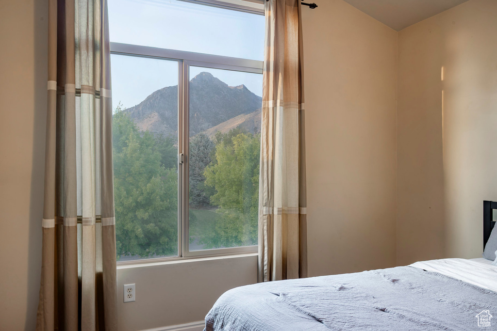 Bedroom featuring a mountain view and baseboards