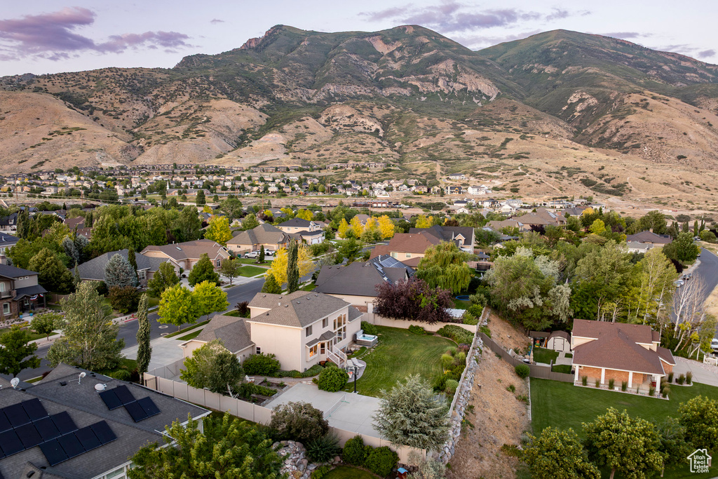Aerial overview of property's location with a mountain backdrop and nearby suburban area