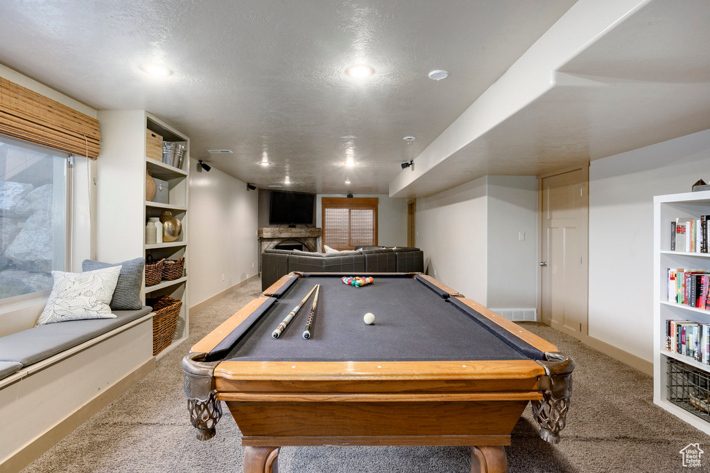 Playroom with carpet flooring, billiards, and a fireplace