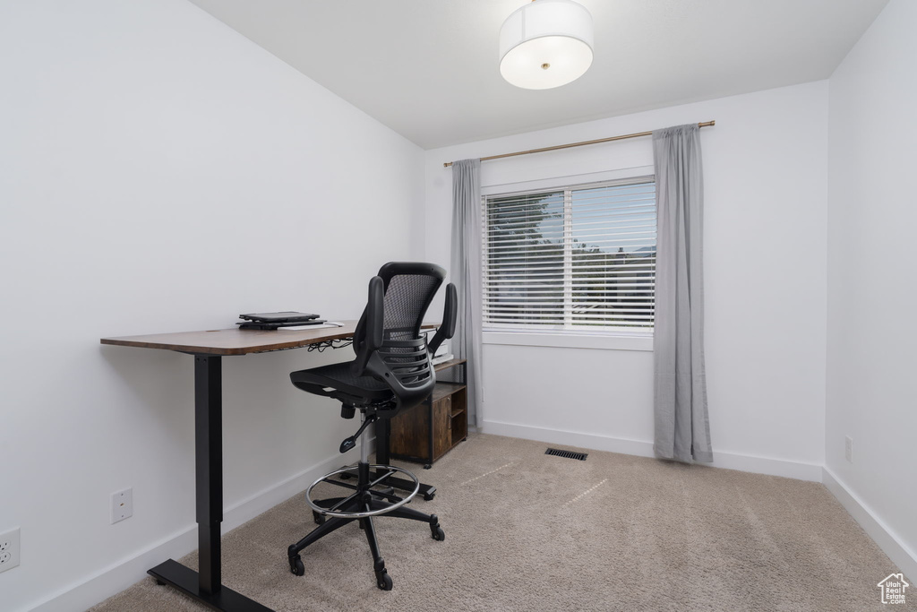 Carpeted office with baseboards