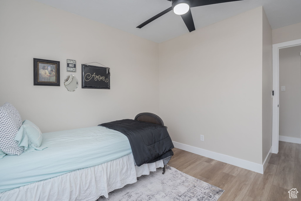 Bedroom featuring wood finished floors and a ceiling fan