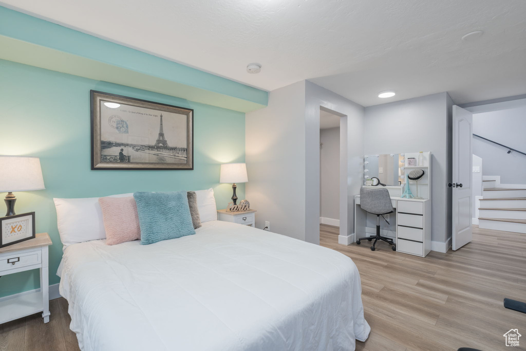 Bedroom with a desk and wood finished floors