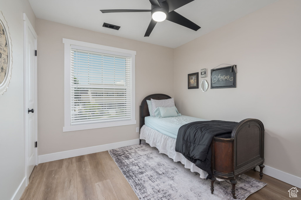 Bedroom featuring wood finished floors and a ceiling fan