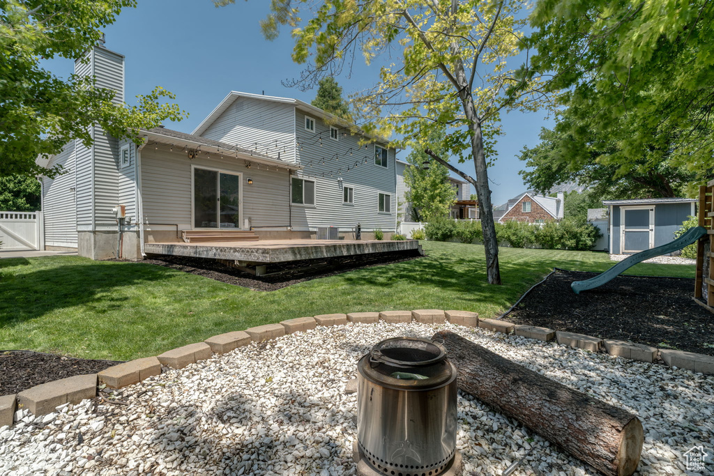 Rear view of property with a playground and a chimney
