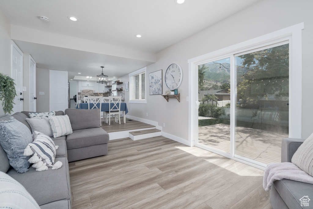 Living room featuring recessed lighting, a chandelier, and light wood-type flooring