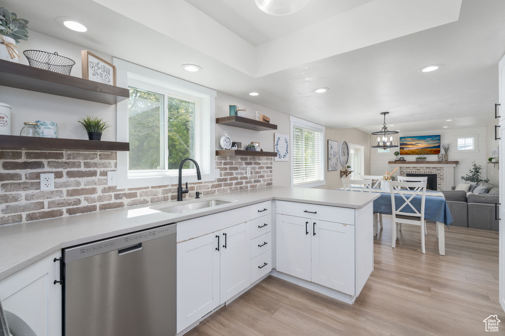 Kitchen with stainless steel dishwasher, open shelves, white cabinets, plenty of natural light, and recessed lighting