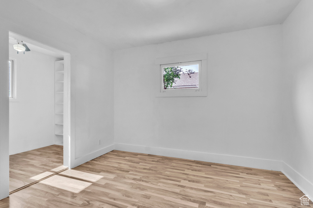 Unfurnished bedroom featuring light wood finished floors and baseboards