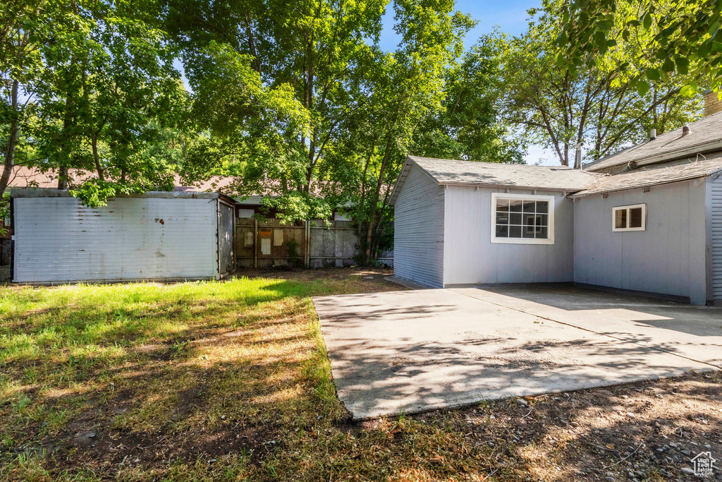 View of yard featuring a patio area and a storage shed