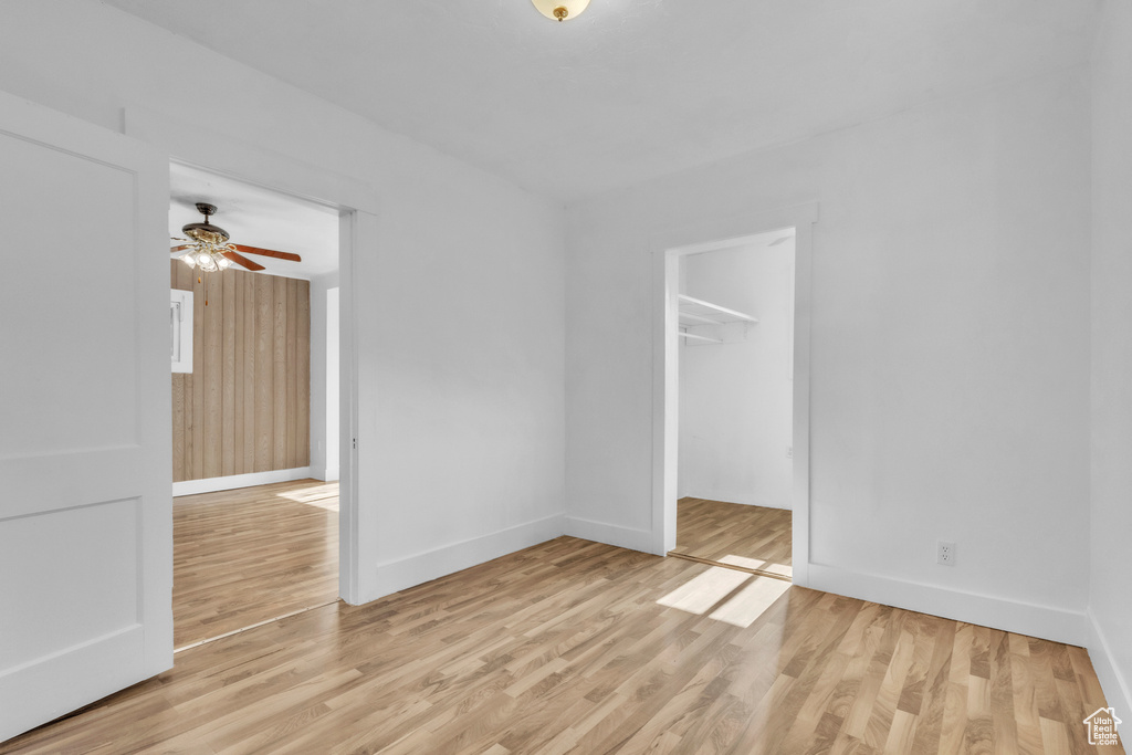 Spare room featuring a ceiling fan and light wood-style floors