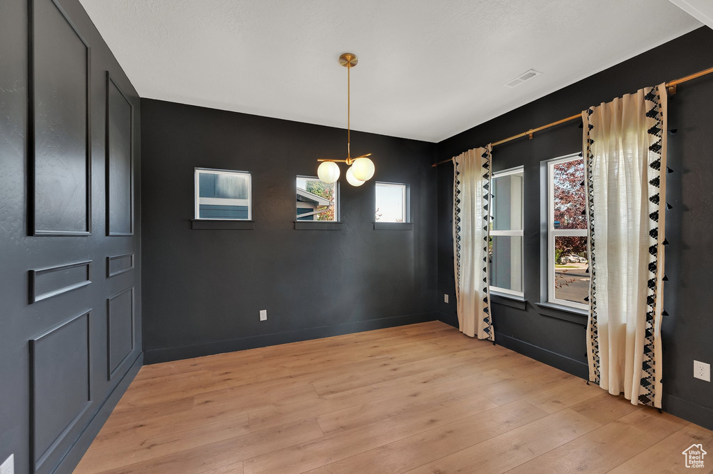 Unfurnished dining area featuring light wood-style floors and baseboards