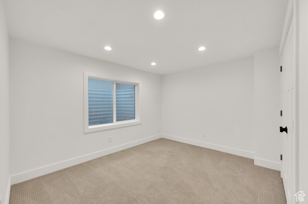Spare room with light carpet and recessed lighting