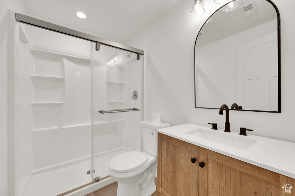 Bathroom featuring a shower stall, vanity, and recessed lighting