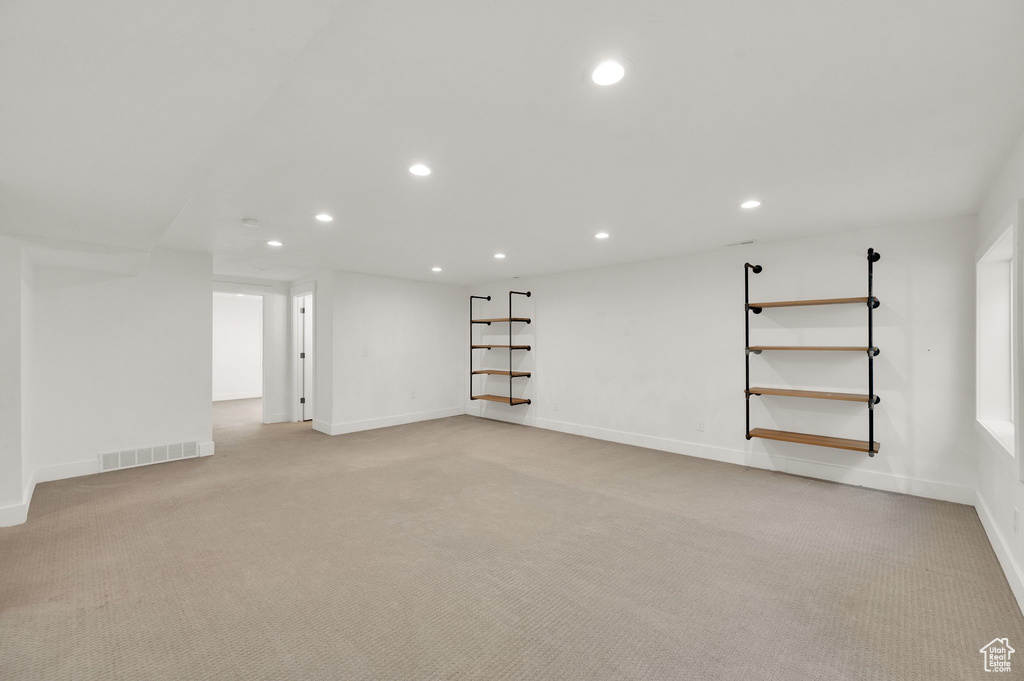 Below grade area featuring recessed lighting and light colored carpet