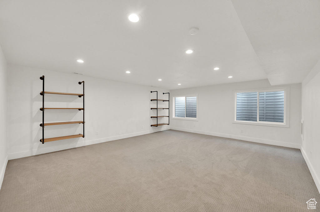 Empty room with recessed lighting and light carpet