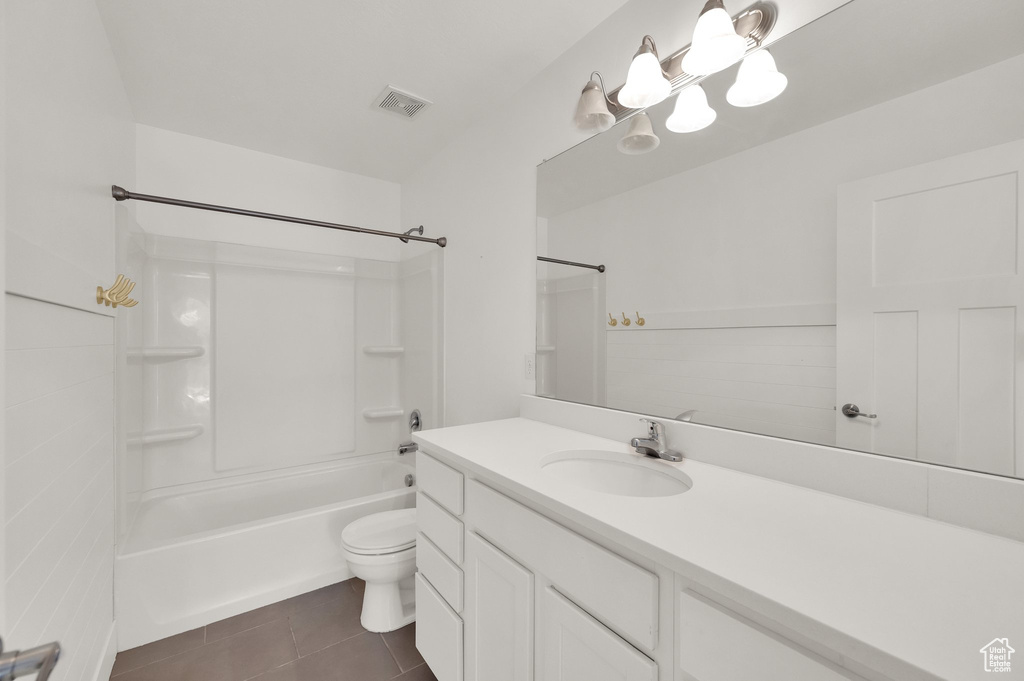 Bathroom featuring vanity, tile patterned floors, and washtub / shower combination