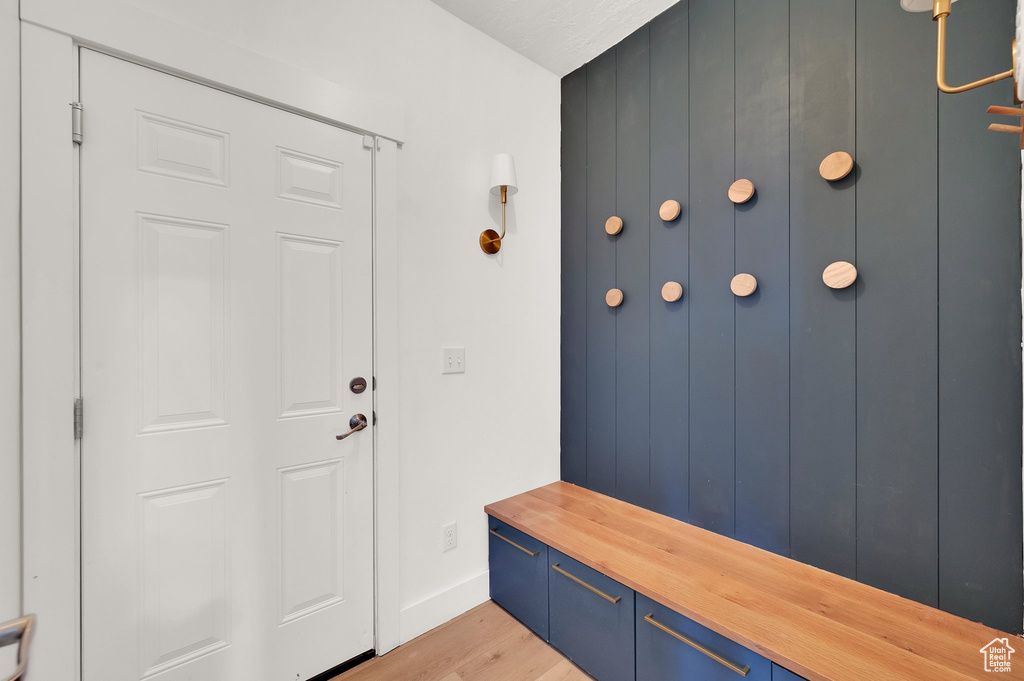 Mudroom with light wood-type flooring and baseboards