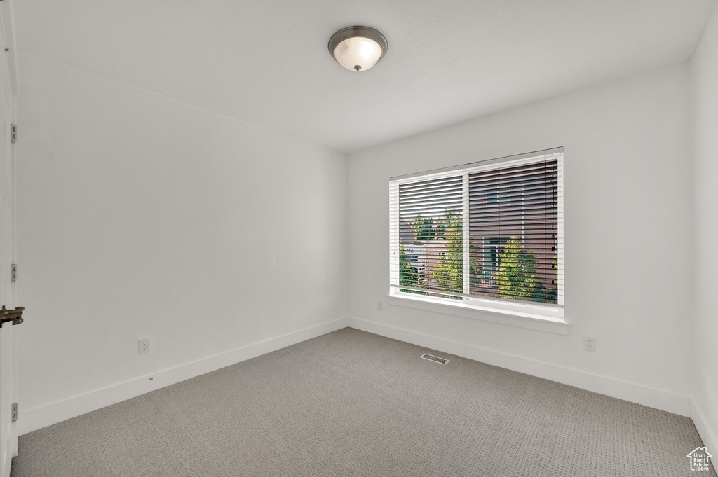 Spare room featuring light colored carpet