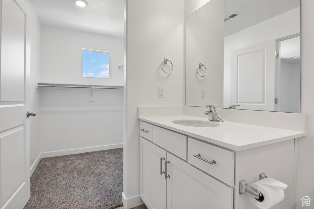 Bathroom with vanity and baseboards