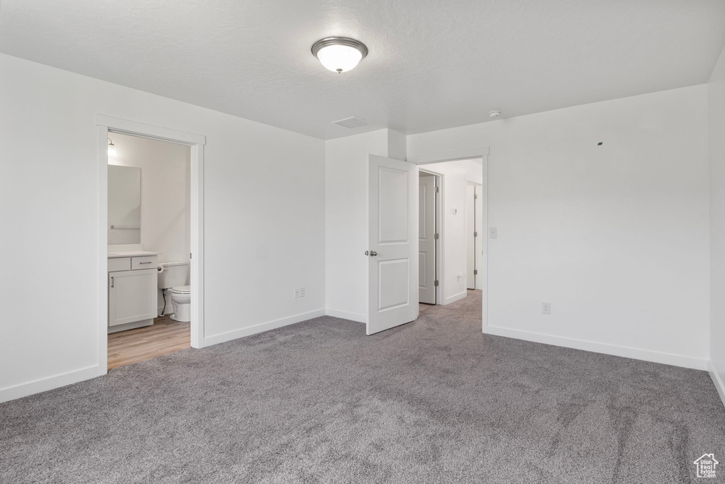 Carpeted spare room with baseboards