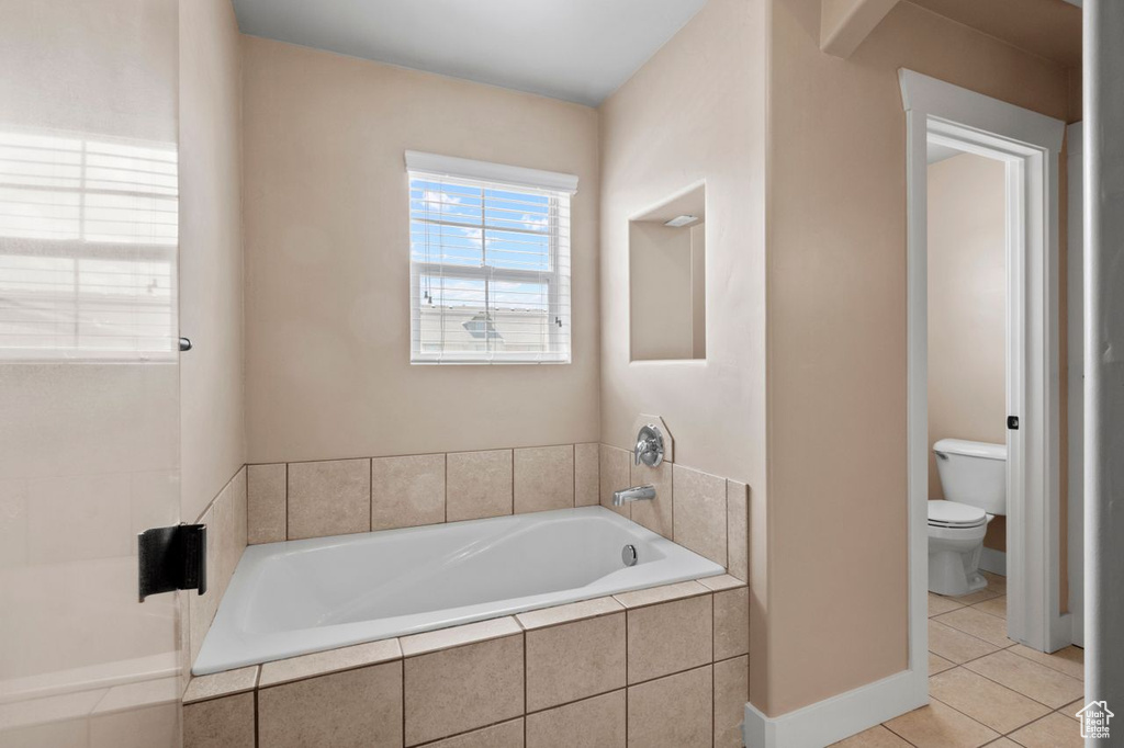 Bathroom featuring a bath and tile patterned floors