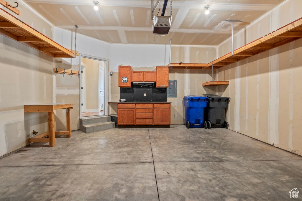 Garage with electric panel and a garage door opener