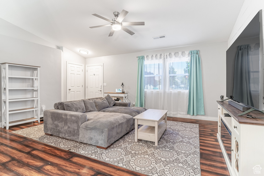 Living area featuring wood finished floors, ceiling fan, and lofted ceiling
